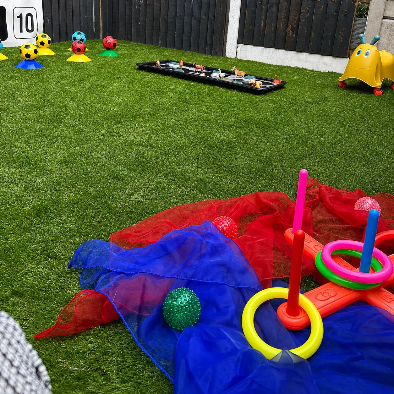 A colourful ring-toss activity prepared on the nursery garden lawn